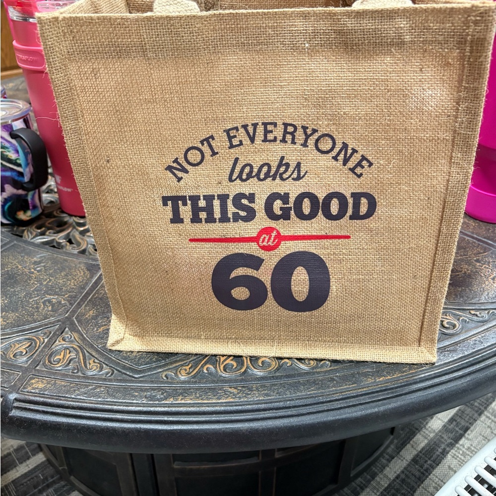 60th birthday gift bag in burlap, with 60th saying on front. Bnnu , displayed.